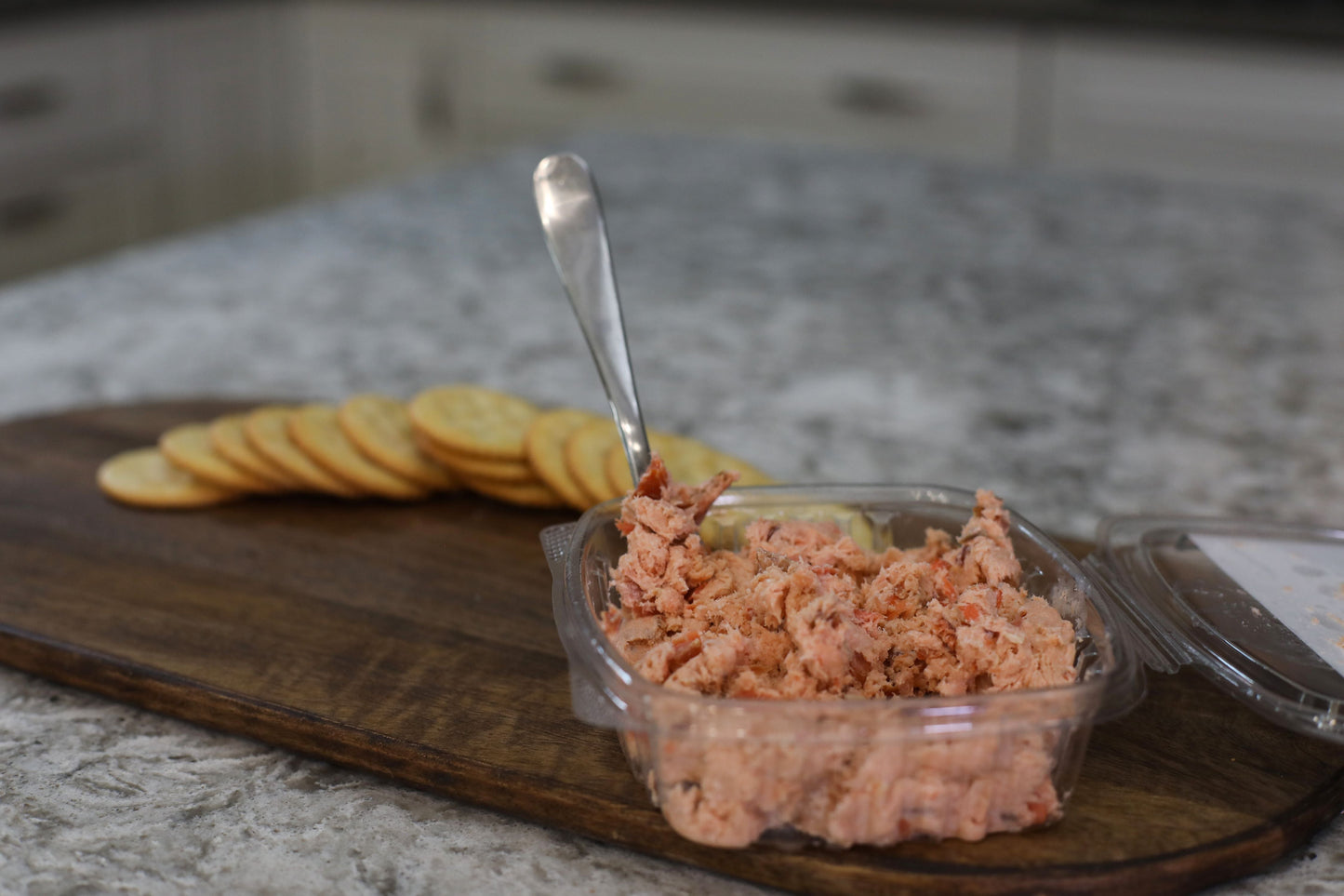 Smoked Alaskan Sockeye Salmon Spread (add - on) - Net To Table Seafoods Smoked wild Alaskan sockeye salmon spread from Net to Table Seafoods served with crackers on a wooden board. Sustainably harvested salmon from Bristol Bay, Alaska.