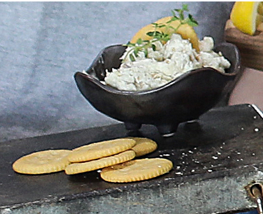 Smoked wild Alaskan sablefish spread in black bowl with lemon and herbs, served with crackers, Net to Table Bristol Bay