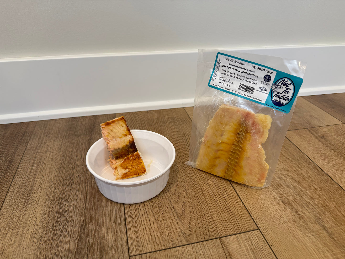 Wild Alaskan Keta salmon pet food from Net to Table Seafoods, with a portion served in a white dish and vacuum-sealed package nearby. Sustainable, wild-caught salmon harvested in Alaska for healthy, natural pet nutrition.
Net to Pet