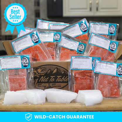 Best Seller: Box of individually vacuum-sealed wild-caught Alaskan sockeye salmon fillets from Net to Table Seafoods, displayed with ice on a kitchen counter. Features the Net to Table logo and Wild-Catch Guarantee for sustainably sourced seafood from small-boat fishermen.
