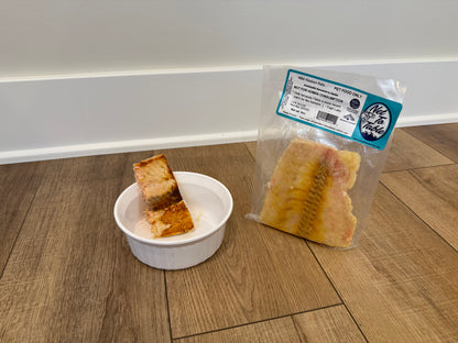 Wild Alaskan Keta salmon pet food vacuum-sealed package next to served portions in white bowl, Net to Table Seafoods