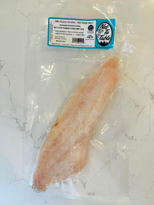 Wild Alaskan Rockfish fillet vacuum-sealed in clear packaging labeled Pet Food Only from Net to Table Seafoods on marble surface